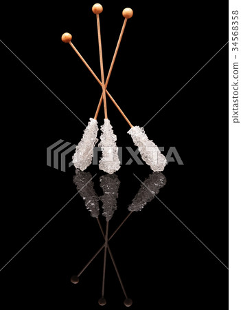 Three standing sticks of white sugar Three standing sticks of white sugar 34568358