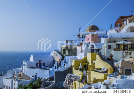 At dusk sun bathes traditional Greek houses At dusk sun bathes traditional Greek houses 34568408