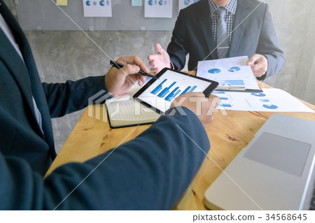 business team disscussing on digital tablet 34568645