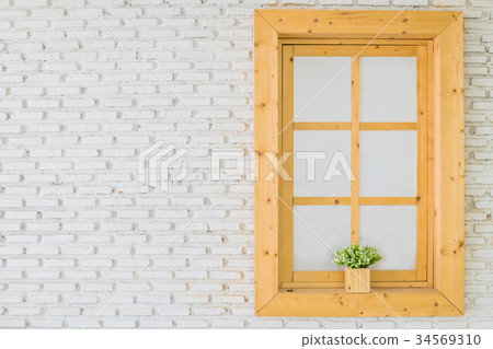 Brown wooden glass window with flowers inside 34569310