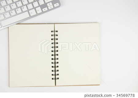Copy space keyboard and blank book isolated Copy space keyboard and blank book isolated 34569778