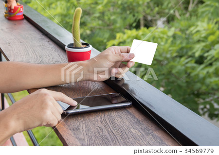 Mock up hand hold blank credit card and touch Mock up hand hold blank credit card and touch 34569779