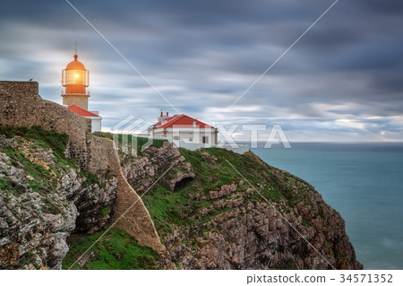 Lighthouse shines out to sea ships. Sagres Cabo Lighthouse shines out to sea ships. Sagres Cabo 34571352
