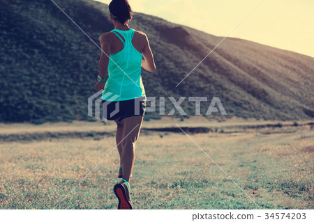 fitness woman trail runner running on mountain fitness woman trail runner running on mountain 34574203