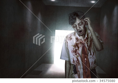 Scary asian zombie with blood and wounded face Scary asian zombie with blood and wounded face 34575080