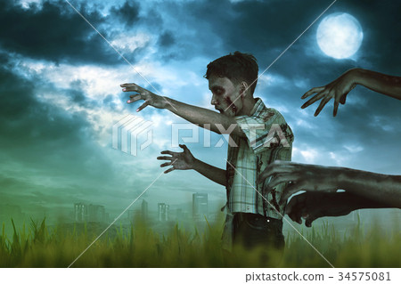 Asian zombie man hand with a claw walking around Asian zombie man hand with a claw walking around 34575081