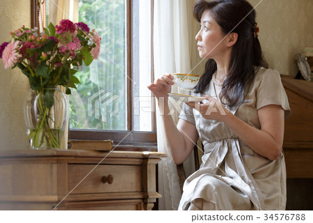 Woman by the window Woman by the window 34576788