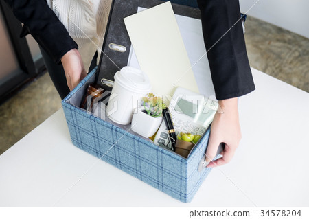 business woman packing personal company belongings when she deci 34578204