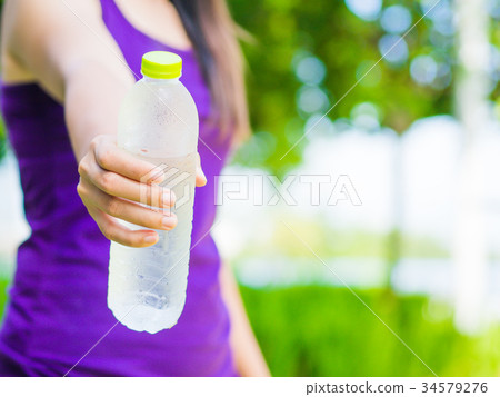 plastic water bottle in woman hand plastic water bottle in woman hand 34579276