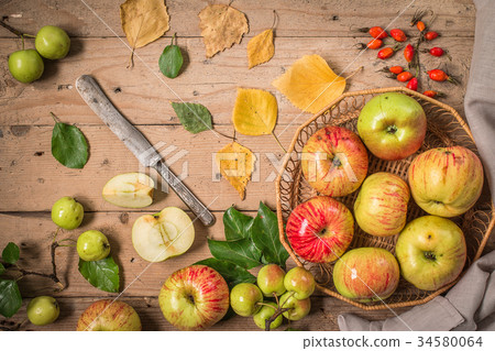 Composition with fresh apples on old wooden table Composition with fresh apples on old wooden table 34580064