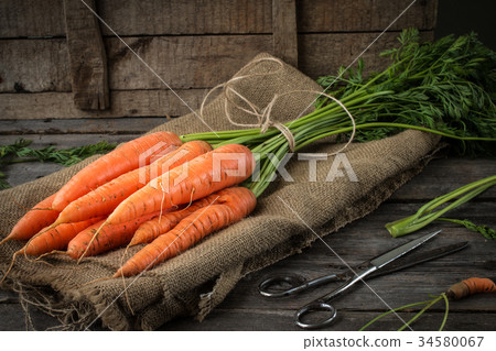 Fresh Organic Carrots  on rustic  table 34580067