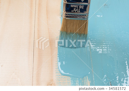 worker paints board worker paints board 34581572