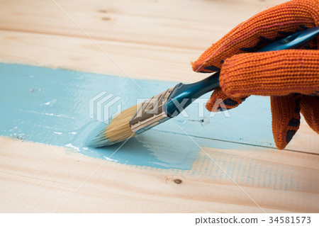 worker paints board worker paints board 34581573