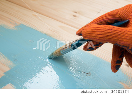 worker paints board worker paints board 34581574