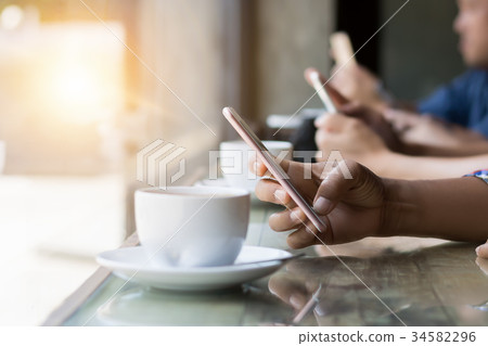 many hand using smartphone in coffee shop 34582296
