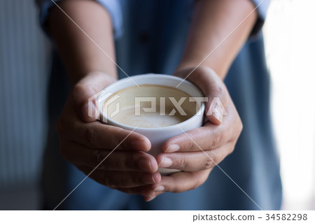 Asian woman holding hot coffee 34582298