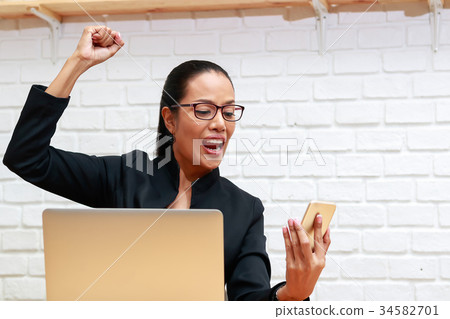 Businesswoman shocked with something in smartphone 34582701