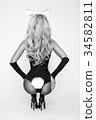 Sexy blonde woman in black costume easter bunny 34582811