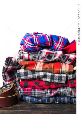 Colorful male shirts on a pile Colorful male shirts on a pile 34584402