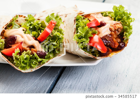 Burrito. Tortilla with meat and beans Burrito. Tortilla with meat and beans 34585517