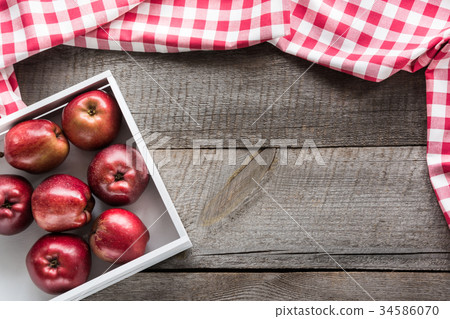 Ripe red apples in birch-box on wooden board. 34586070