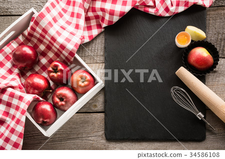 Ripe red apples in birch-box on wooden board. 34586108