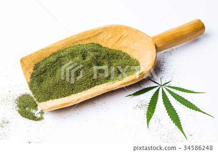 Marijuana powder in a big wooden spoon isolated Marijuana powder in a big wooden spoon isolated 34586248