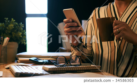 Checking smartphone Checking smartphone 34586303