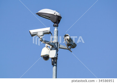 security cctv cameras on a pole with blue sky 34586951