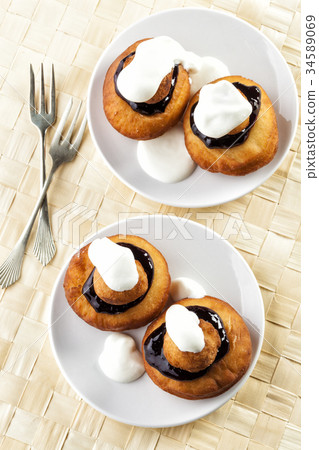 Sweet dessert of beignets with chocolate and cream 34589069