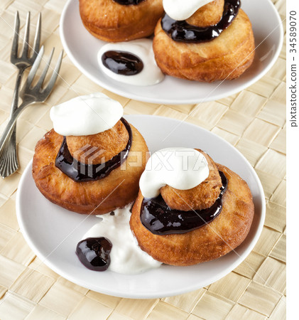 Sweet dessert of beignets with chocolate and cream 34589070
