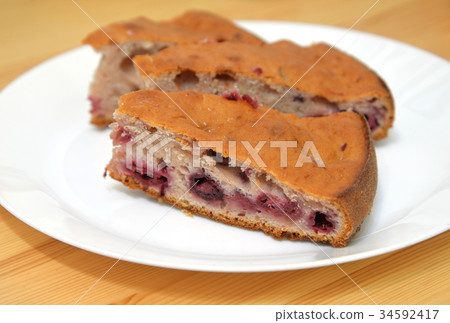 Cherry pie on a plate. 34592417