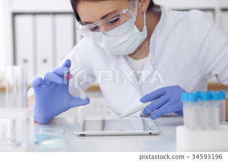 Close-up of professional female scientist in Close-up of professional female scientist in 34593196