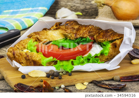 Croissant with cheese and tomato with dried garlic 34594316