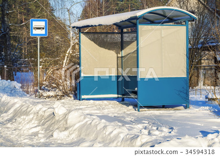 Bus shelter near snow covered road in winter Bus shelter near snow covered road in winter 34594318