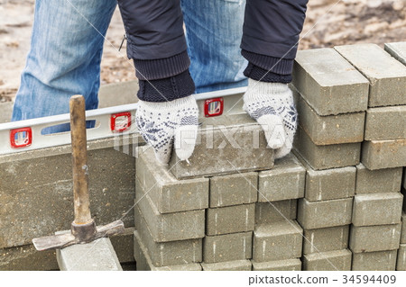 Worker with paving bricks Worker with paving bricks 34594409