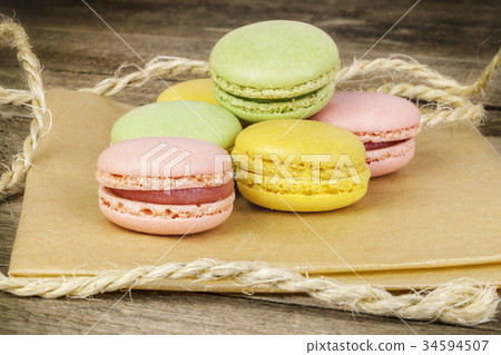 Macrons in various colors on paper and wood 34594507