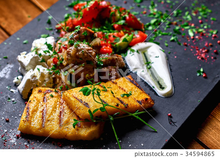 Grilled polenta, hominy with meat  34594865