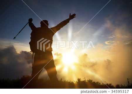 man on the top of mountain watching sunrise man on the top of mountain watching sunrise 34595317