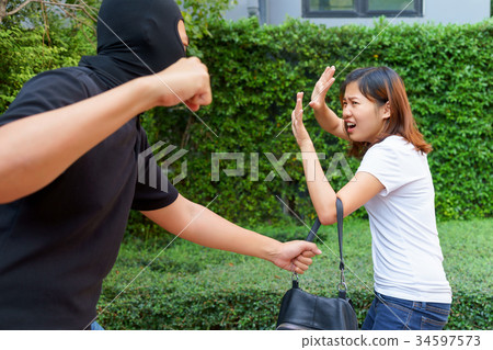 Thief fighting and stealing handbag from woman 34597573