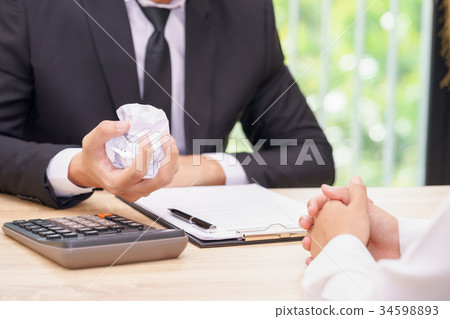 Hands of businessman crumple agreement Hands of businessman crumple agreement 34598893