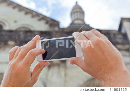 Tourist taking photo of Perigueux, France Tourist taking photo of Perigueux, France 34601515