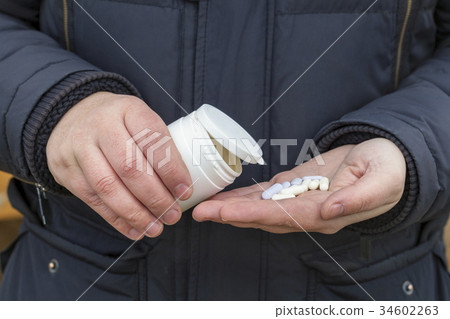 Close up of hands with pills 34602263
