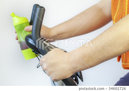 Man using exercise bike Man using exercise bike 34602726