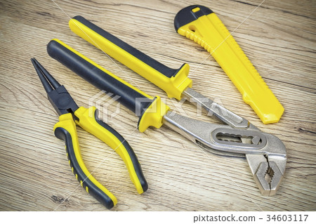 Tools in yellow on wood 34603117