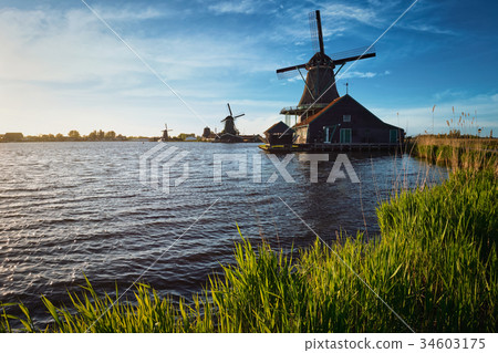 Windmills at Zaanse Schans in Holland on sunset 34603175