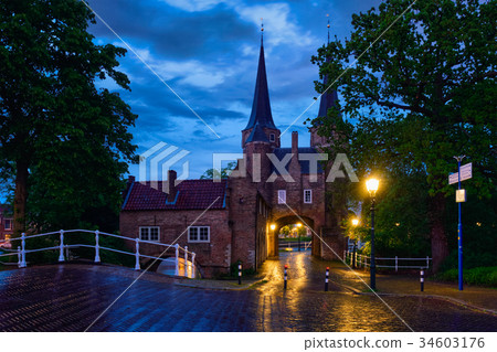 Oostport (Eastern Gate) of Delft at night. Delft 34603176