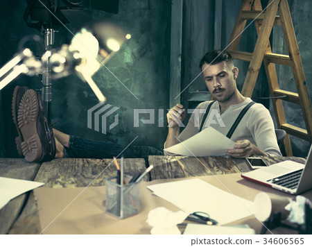 Portrait of a bearded businessman who is checking 34606565