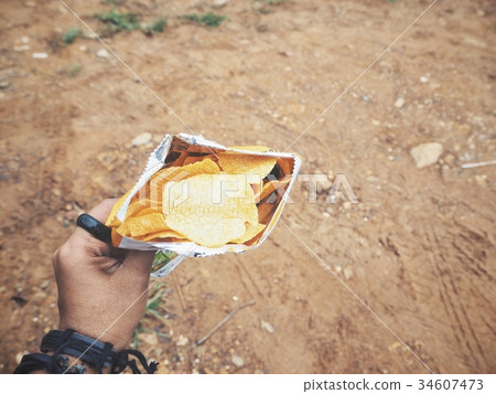 Selfie of hand with potato chips 34607473