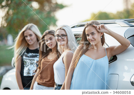 The young women standing near the car The young women standing near the car 34608058